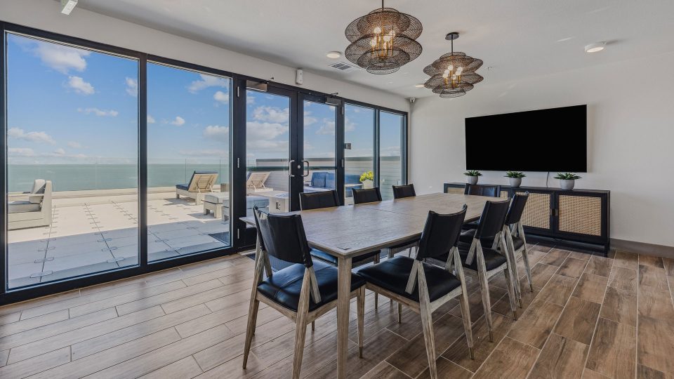 a dining room with a large table and glass doors at The  Alexa